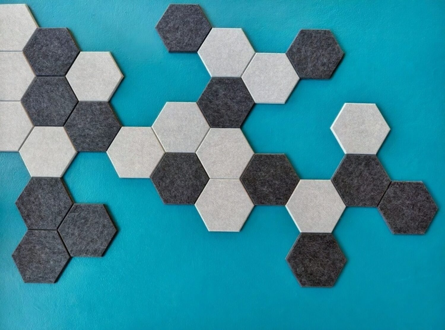 stock-photo-light-grey-perforated-wooden-acoustic-panels-on-blue-concrete-wall-2590335909